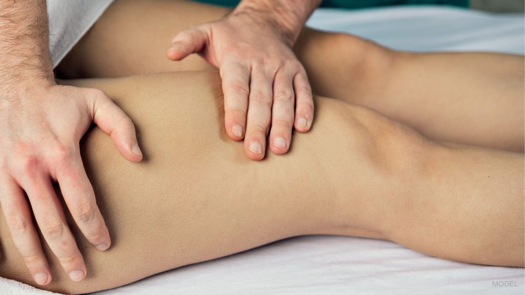 Woman having her legs examined by a medical professional (MODELS)