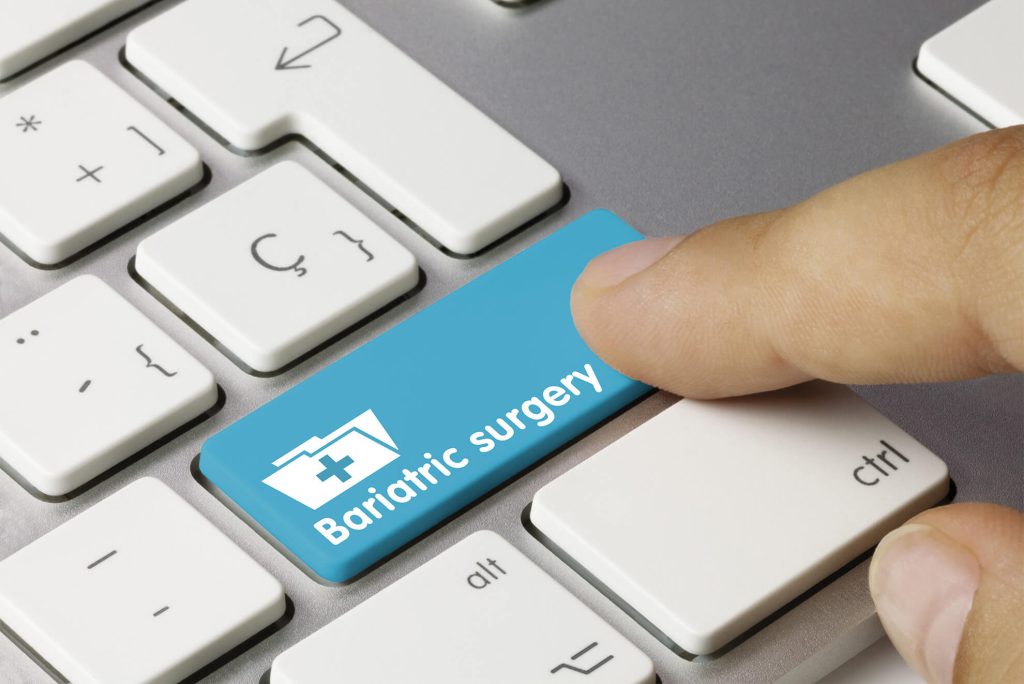 Finger clicking a Bariatric surgery button on the keyboard